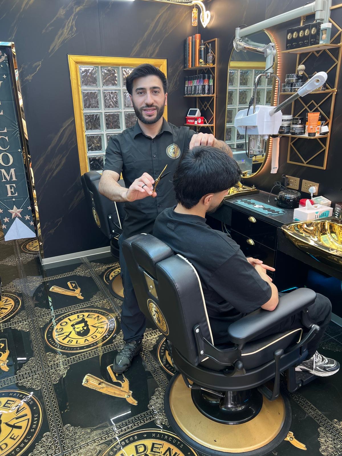 Mahmoud cutting a client's hair at Golden Blade Jordanhill